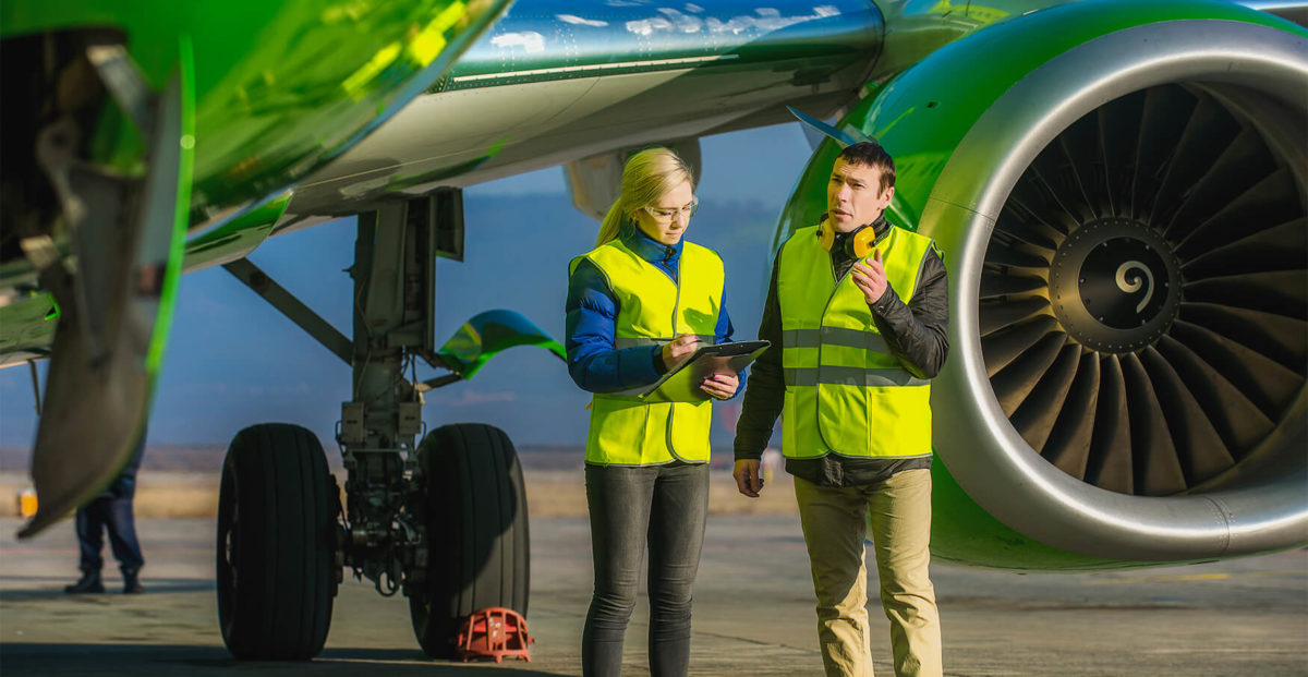 Ground Crew talking by a plane
